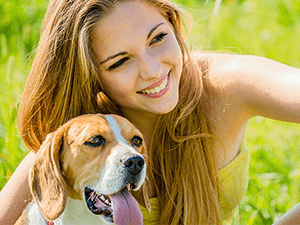 lady in yellow tube with dog on her side