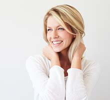 blonde girl in white sweater smiling